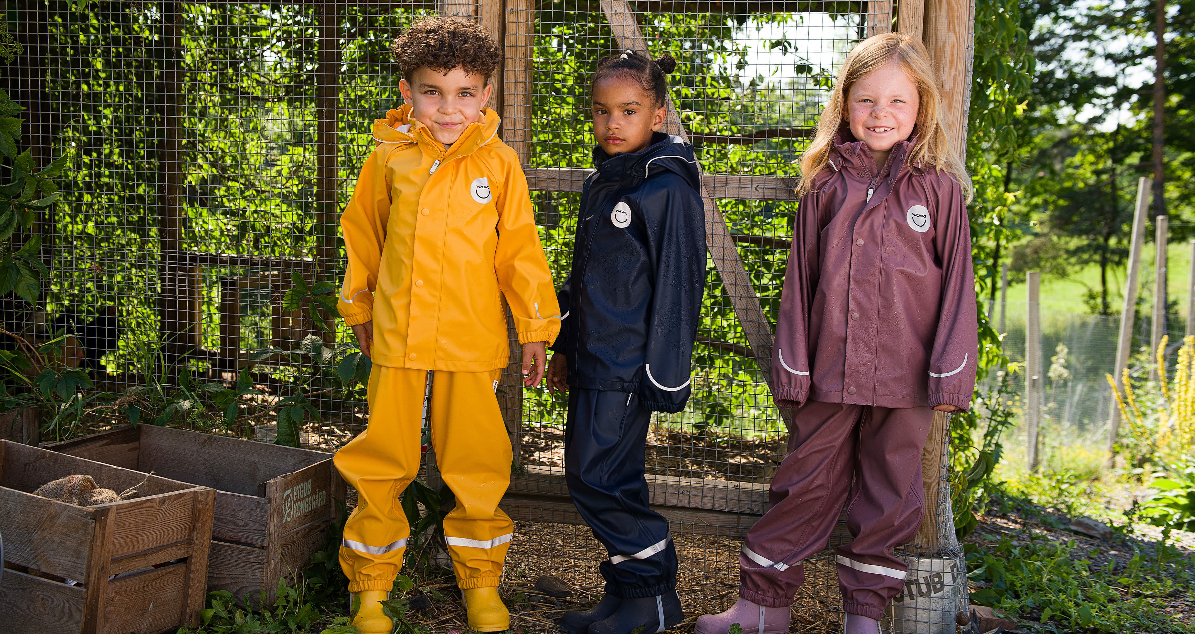 Three playing children wearing rain gear from Viking